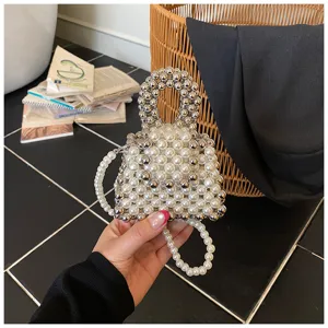 Detail view of the handmade beaded mini handbag, featuring alternating pearls and silver balls.