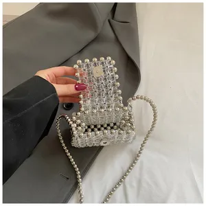 Detailed close-up of a clear acrylic beaded mini bag with silver chain strap and magnetic clasp.