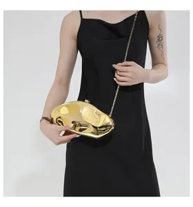 Stylish gold acrylic hard shell evening clutch bag with metal chain strap for women.