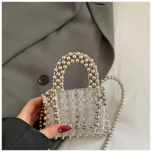 Handmade beaded mini crossbody bag, clear and silver acrylic beads design, chic compact accessory.