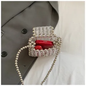 Handmade clear beaded mini crossbody bag, stylish transparent pearl chain makeup handbag detail.