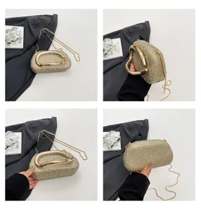 Detailed view of the sparkling rhinestone evening bag with elegant curved gold metal handle and chain.