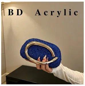 Exquisite blue rhinestone acrylic evening clutch bag with striking gold metal ring handle.