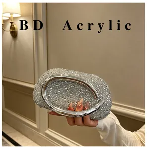Close-up view of stunning rhinestone acrylic evening clutch bag featuring metal ring handle.