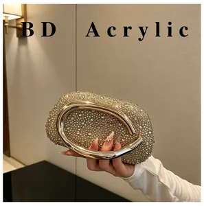 Rhinestone evening clutch bag detail view, sparkling crystals with metallic ring handle.