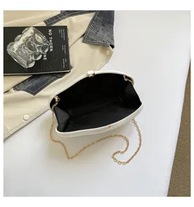 White acrylic hard shell evening bag detail view, stylish gold chain shoulder bag for women.