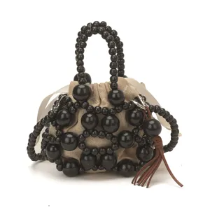 Elegante bolso de mano artesanal con cuentas de madera negra y bolsa de lona para mujer