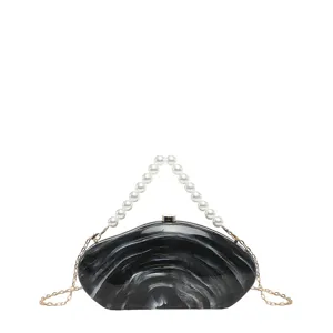 Exquisite black and white marble acrylic evening clutch featuring pearl handle and chic chain.