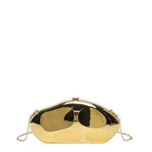 Gold metal clutch bag, irregular abstract design with chain strap, luxury evening purse.