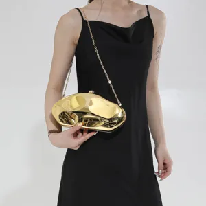 Metallic gold sculptural clutch bag with chain strap, ideal for evening parties and events.