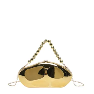 Gold acrylic hard shell evening clutch bag featuring a beaded handle and a chain strap.