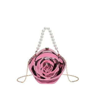 Detailed closeup view of the pink rose-shaped acrylic evening clutch with pearl handle.