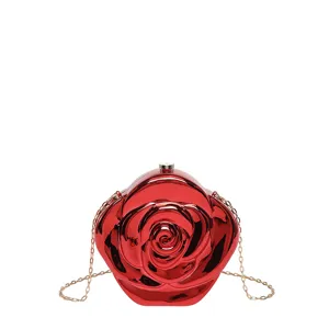 Glossy red rose acrylic clutch detail, metallic gold chain strap, luxury evening bag close-up.