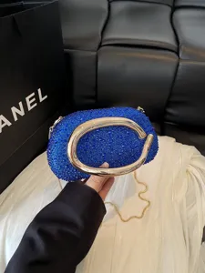 Luxury blue rhinestone evening bag with gold metal handle and chain strap for party and wedding.