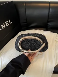 Elegant black rhinestone evening bag with luxury gold metal handle, chic crossbody chain.