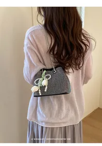 Detailed shot of the stylish rhinestone shoulder bag featuring elegant pearl and tulip pendant.