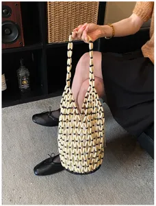 Detailed view of trendy acrylic beaded bucket bag with mesh design and white inner pouch.