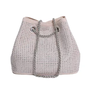 Close-up view of the sparkling rhinestone bucket bag with shiny silver chain detail.