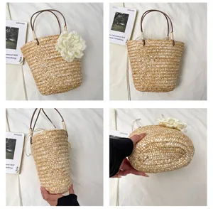 Straw woven handbag detail showcasing natural texture, floral decoration, and sturdy handles.