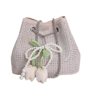 Rhinestone chain bucket bag for women, stylish crossbody shoulder bag with pearl tulip charms.