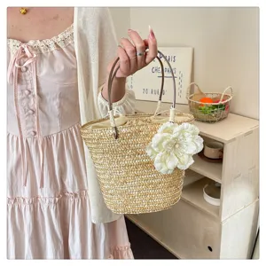Natural straw woven handbag with elegant flower decor, perfect summer beach casual bag.
