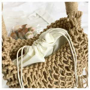 Detailed shot of hollow woven bucket bag with white drawstring inner lining and sturdy handles.