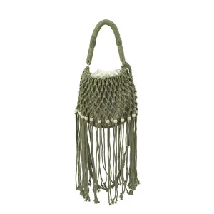 Green macrame bucket bag detail, handmade hollow fringe design with wooden bead accents.