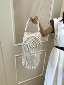 Woven macrame bucket bag with fringe and wooden beads, chic beach handbag for women.