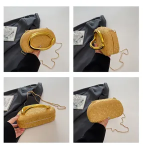 Luxury gold textured evening bag with unique metal handle and chain strap for women.