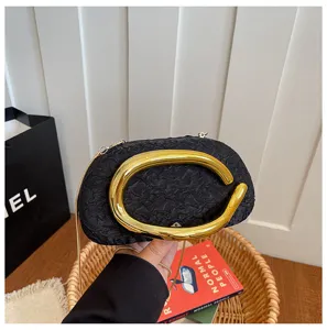 Black evening bag with gold irregular metal handle and chain strap for women chic fashion