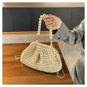 Pearl chain straw woven handbag for women, chic beach clutch bag with metal strap.