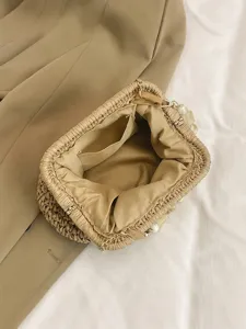 Chic straw woven crossbody bag with elegant pearl chain, perfect for summer beach and vacation.