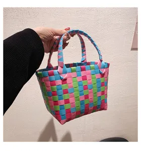 Colorful woven handbag detail shot, handmade multi-color plastic basket bag for daily use.