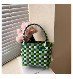 Handmade green white checkered woven basket handbag with pink flower decor detail shot