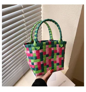 Handmade woven handbag detail, colorful ribbon pattern, stylish casual beach tote bag.