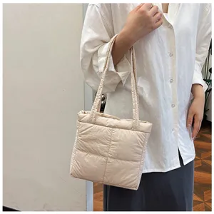 Minimalist beige padded shoulder bag for women, stylish autumn winter commute tote handbag.