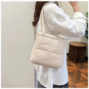 Beige quilted shoulder bag for women, soft puffer underarm bag, casual minimalist style.