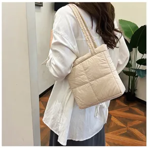Detailed view of the stylish quilted puffer shoulder bag, featuring soft padding and texture.