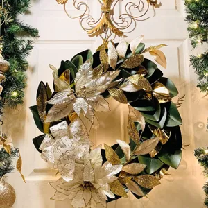 Christmas decorative wreath with green leaves, gold glitter flowers, and bow for door decor