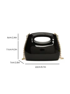 Black acrylic evening clutch bag with gold chain strap, stylish hard-shell mini purse for women.