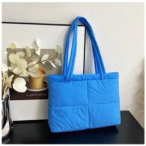 Detail view of the stylish blue quilted puffer tote bag, perfect for autumn and winter daily commute.