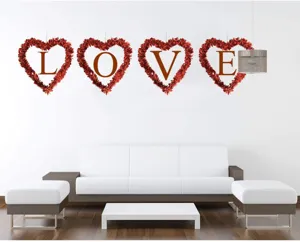 Heart shaped tinsel wreath with LOVE letters, perfect wall decor for weddings and Valentine's Day.