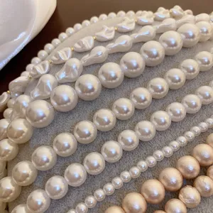 Detailed close-up of multiple pearl necklace strands featuring baroque and round pearls.