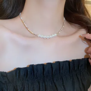 Closeup detail view of the elegant pearl choker necklace, showcasing delicate chain link design.