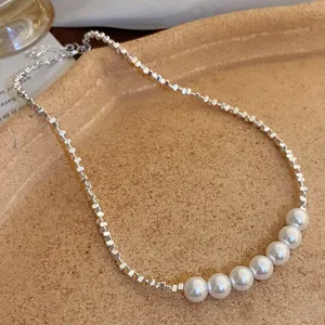 Close-up detail of a French vintage square bead and pearl spliced clavicle necklace.