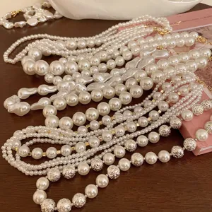 Detailed shot of French vintage baroque pearl necklaces, elegant layered collarbone chain jewelry.