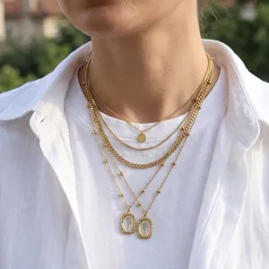 Multi-layer gold chain necklace with vintage pendant, elegant layered jewelry for women.