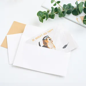 Minimalist white and kraft paper envelopes with cute beagle greeting card flat lay style.