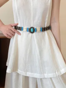 Bohemian beaded waist belt detail showing ethnic style retro design with turquoise stone buckle.
