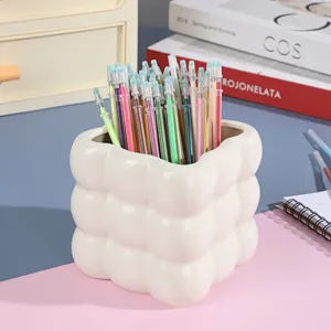Colorful gel pen refills set in white holder for DIY journal sketching and office writing.